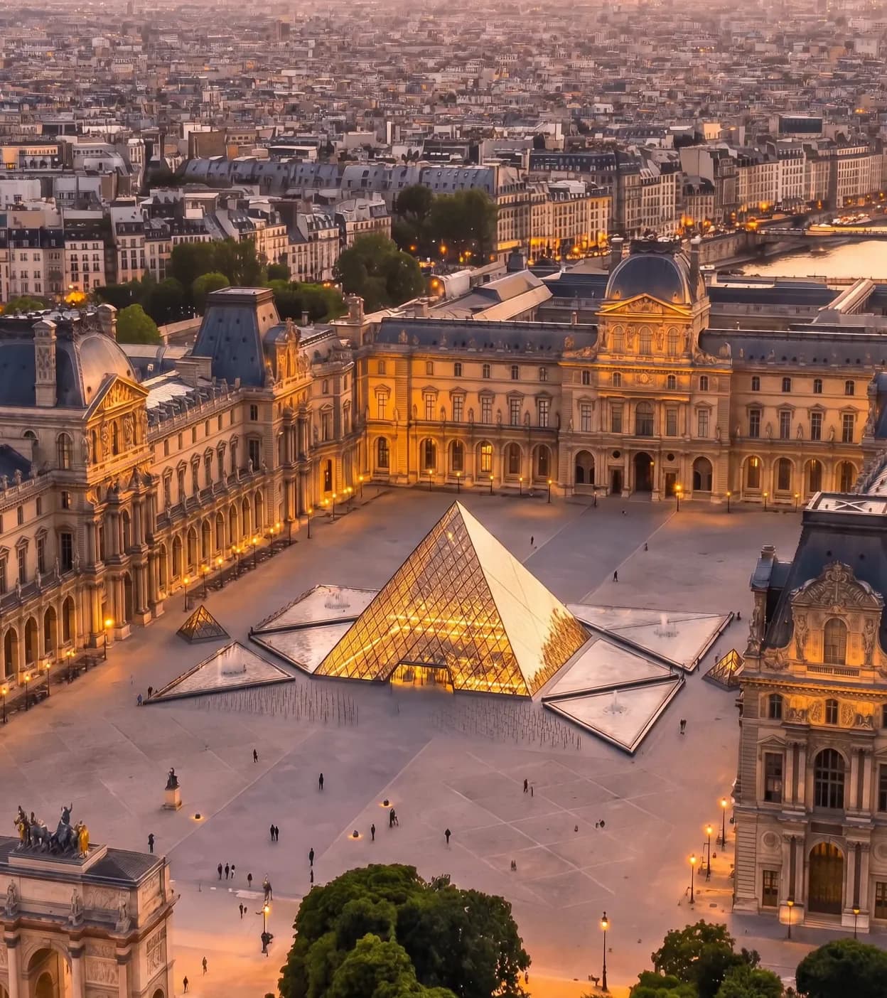 The Louvre Palace and its glass pyramid at dusk, seen from above