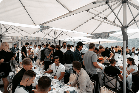 The media lunch under parasols beside the Louvre pyramid