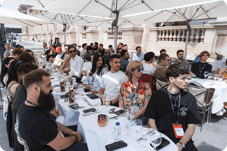 A long table of media guests at the Louvre