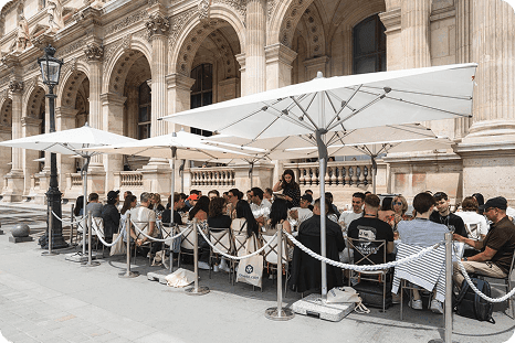 The media lunch tables against the Louvre façade